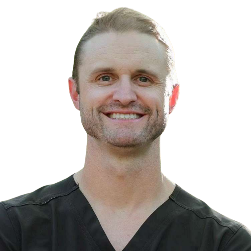 Smiling man in black scrubs looking at the camera, portrait in a clinical setting (healthcare professional).
